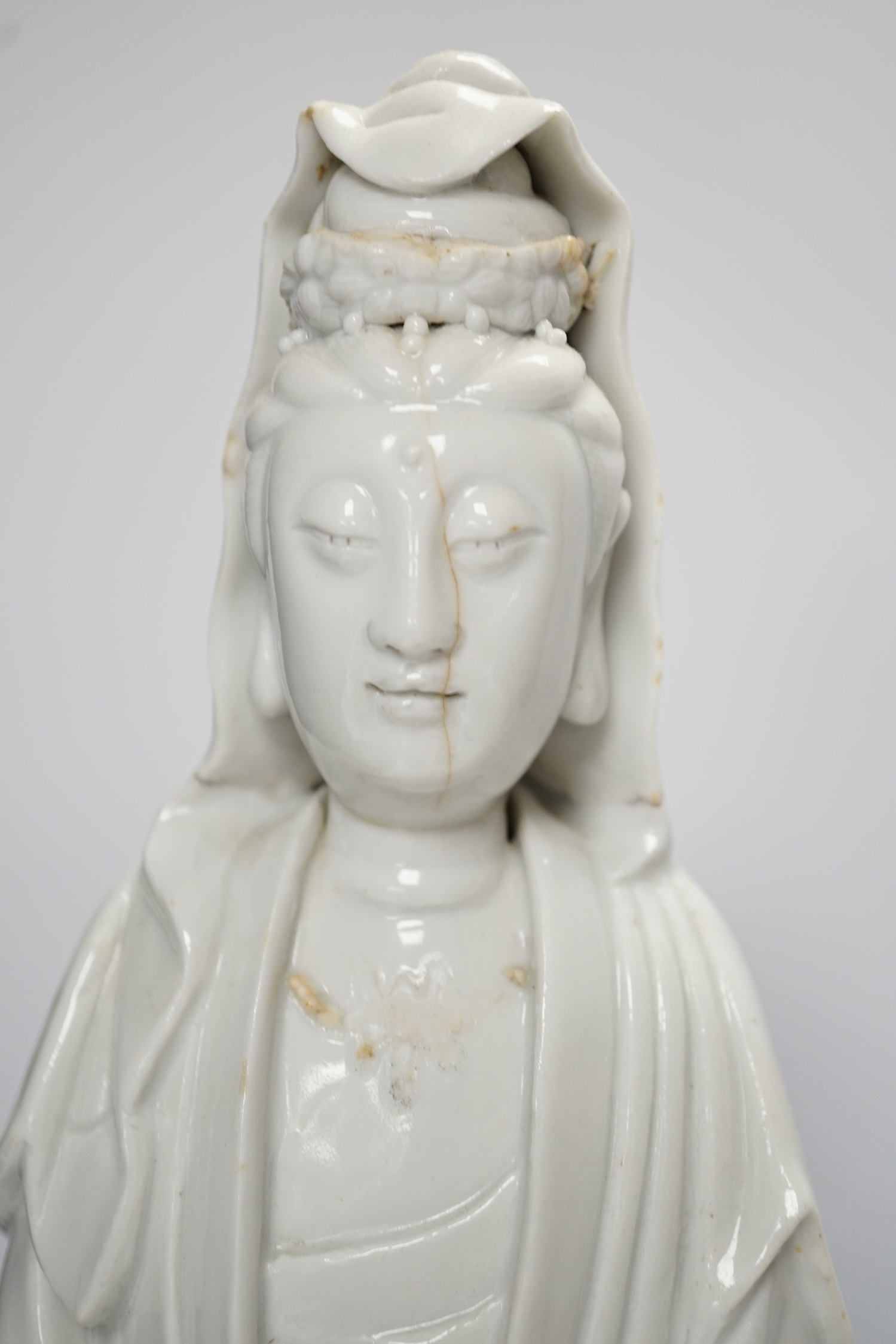 Seven Chinese blanc de chine pieces to include a pair of lion dogs and a phoenix, 17th century and later, largest 44cm high. Condition - varies, poor to fair